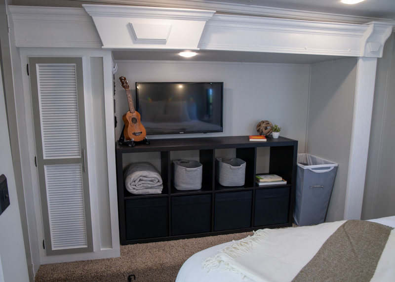The bedroom storage is significantly brighter with light colored paint and a new storage unit.